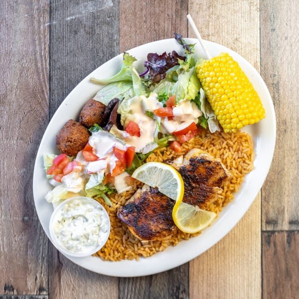 River Smith's grilled catfish with rice, hushpuppies, salad, corn on the cob, and tartar sauce.